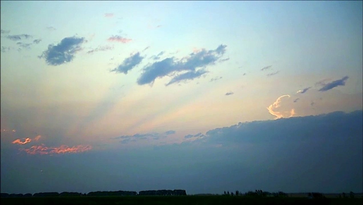MCH 403 WHITE CLOUDS STREAKING ACROSS THE SKY IN THE HOT SUMMER HEAT.