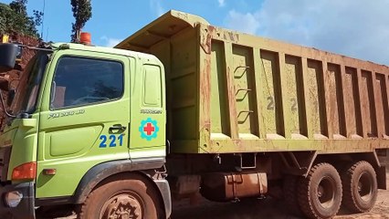 Excavator cutting mountain, excavator loading stone to dump truck