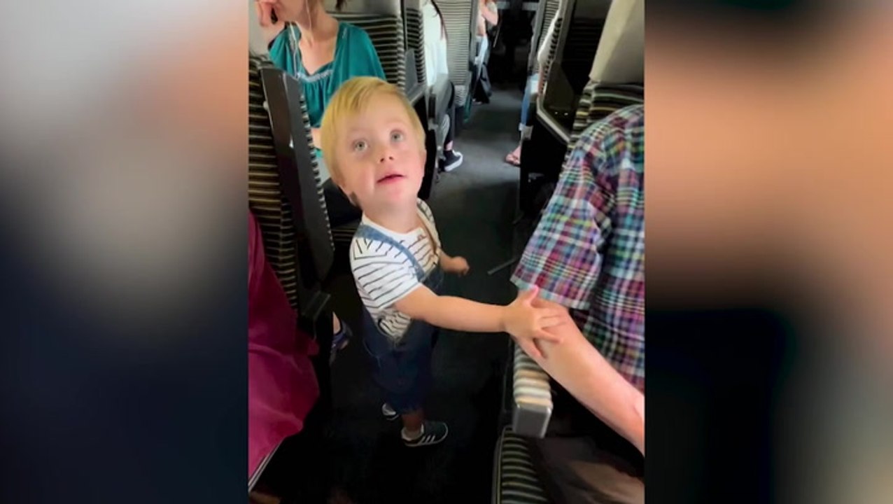 ‘His passion is to meet others’: Toddler with Down’s Syndrome walks down train aisle to greet every passenger