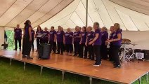 The pop choir performing in the theatre tent at Launceston Show 2023