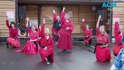 Kate Bush-themed flash mob at Harvest Market | The Examiner | July 29, 2023