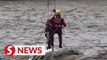 China floods: Man rescued from floating car