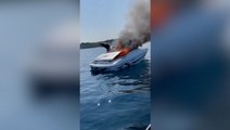 Moment boat bursts into flames as crew dive to safety into Lake Michigan