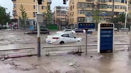 Roads turn to rivers in Beijing after typhoon