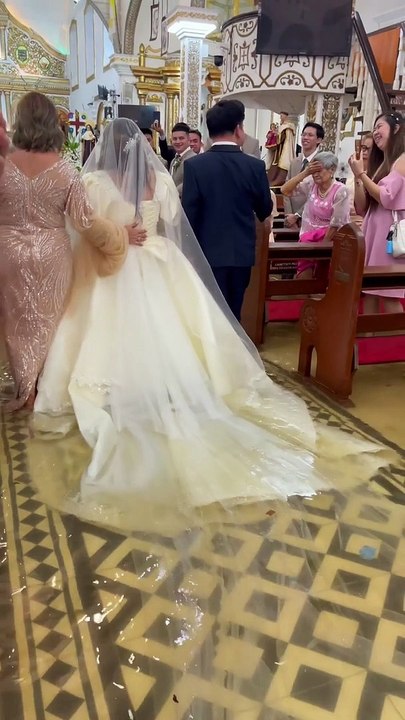 Watch: Bride wades through flooded aisle in wedding dress, video goes viral