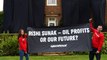 Greenpeace activists scale Rishi Sunak's mansion and drape it in black fabric