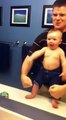 Baby adorably flexes muscles with dad