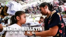 In preparation for the upcoming school year, Parents buy new uniforms for their children in Divisoria