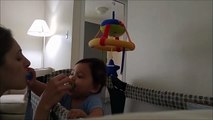 Baby exchanges pacifiers with mommy