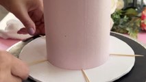 Cake Artist decorates a lavender haze cake by piping the frosting *Amazing Cake Art*