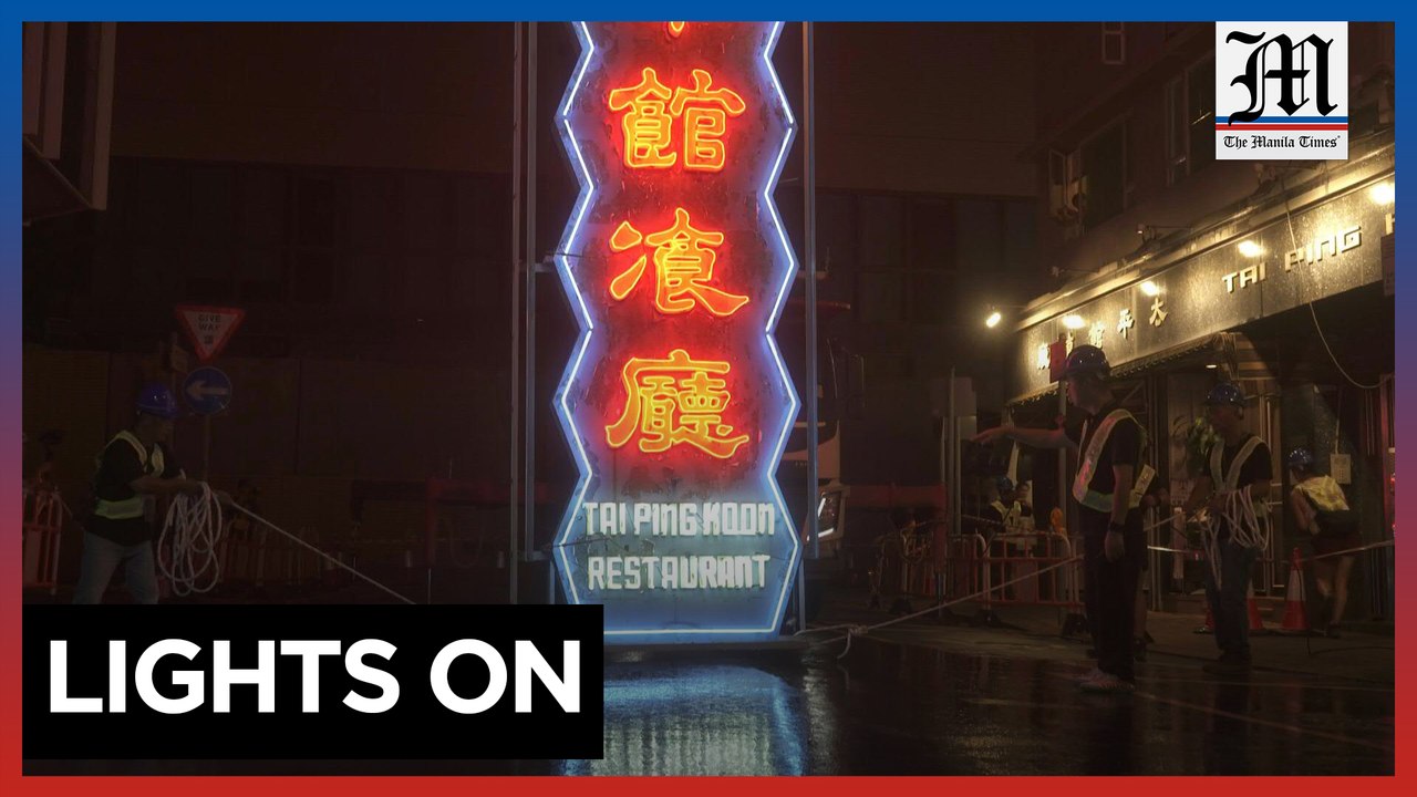 Hong Kong's fading neon signs shine again in ex...