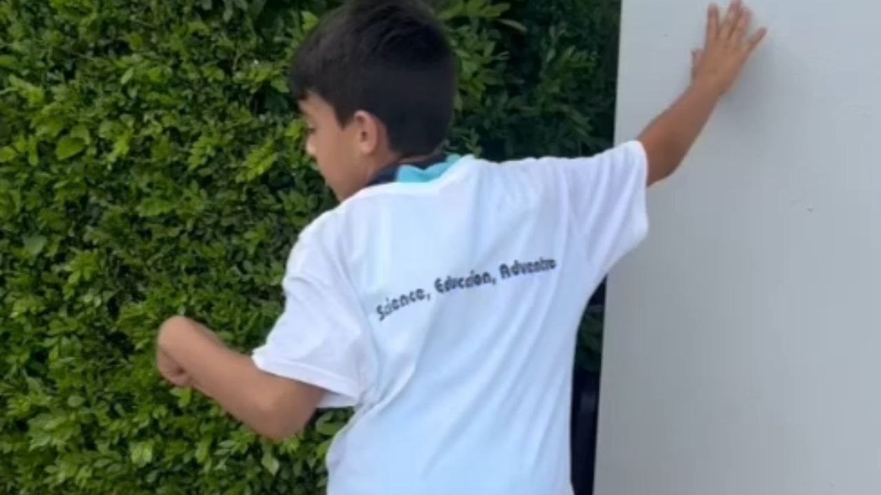 Young Iguana Hunters successfully catch a big one hiding in the side bushes of their home