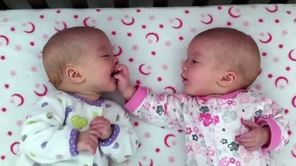 Identical twin girls engage in deep conversation