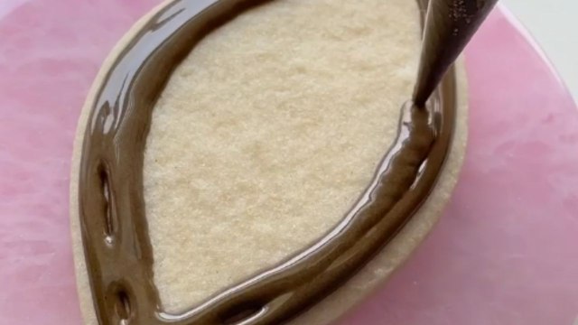 Woman scores DELECTABLE touchdown by decorating a Super Bowl-Worthy football cookie