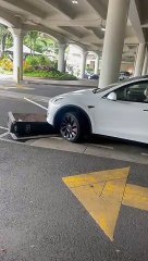 Tesla Driver Runs Over Charging Station and Drags It Away