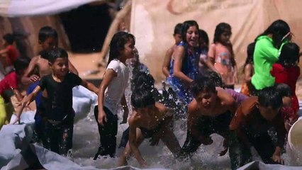 Struggling to cool down in Syria's displaced camps amid scorching temperatures