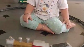 Very cute girl playing with toy train 