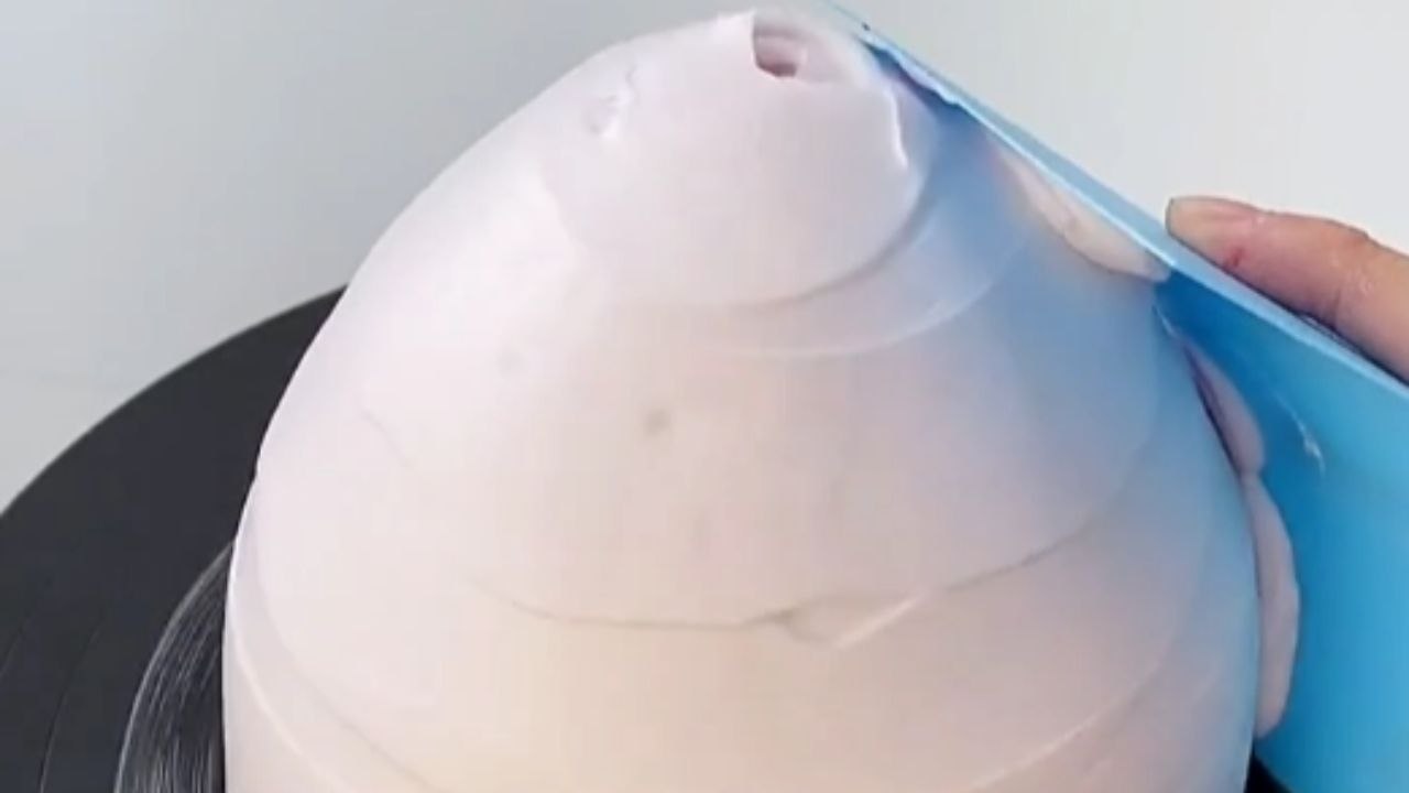 Dessert artist uses her piping prowess to decorate a DRESS-icious doll cake