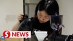Visually impaired coffee barista brews dream in Guangzhou