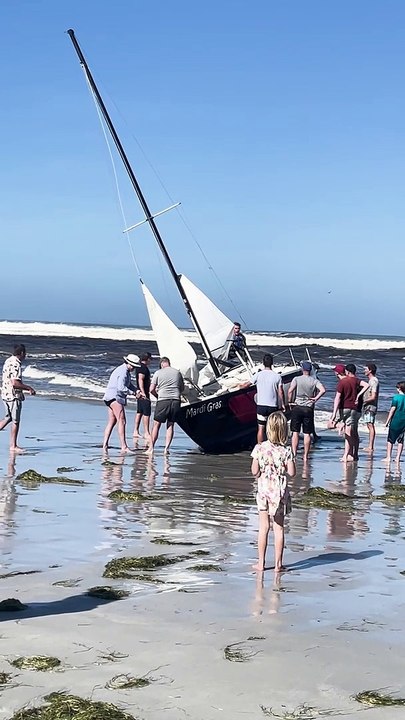 Beachgoers Work to Rescue Boat