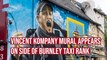 Burnley boss Vincent Kompany depicted in paint on the road to Turf Moor