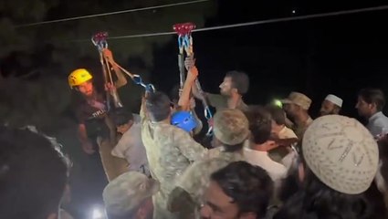 Eight people saved from cable car stuck dangling above canyon in Pakistan