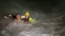 Swimmer battles treacherous sea waves in darkness before rescuers pull him to safety