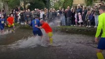 Football match in river draws huge crowds in Cotswold village
