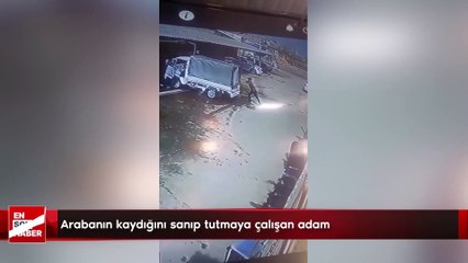 Arabanın kaydığını sanıp tutmaya çalışan adam