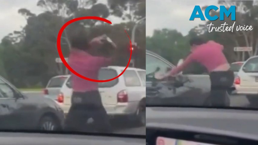 A woman kicks a car and smashes a drivers window in a frightening road rage attack in Adelaide leaving the driver with cuts and bruises on her face.