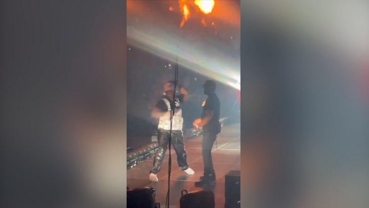 Moment 50 Cent appears to throw malfunctioning mic off stage during LA concert