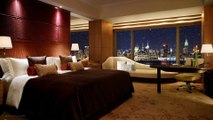 Luxurious bedroom with a view of New York city during a soft snowfall