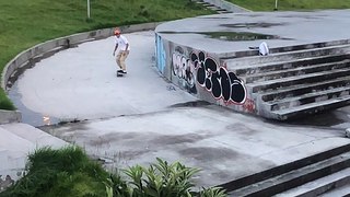 Skateboarder ollies set of stairs and lands on his ankle