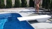 Fancy Diving Jumps off Diving Board in Pool