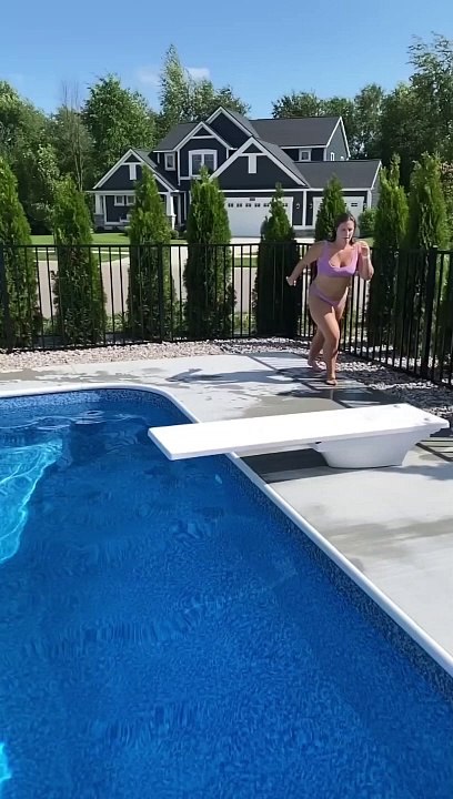 Fancy Diving Jumps off Diving Board in Pool