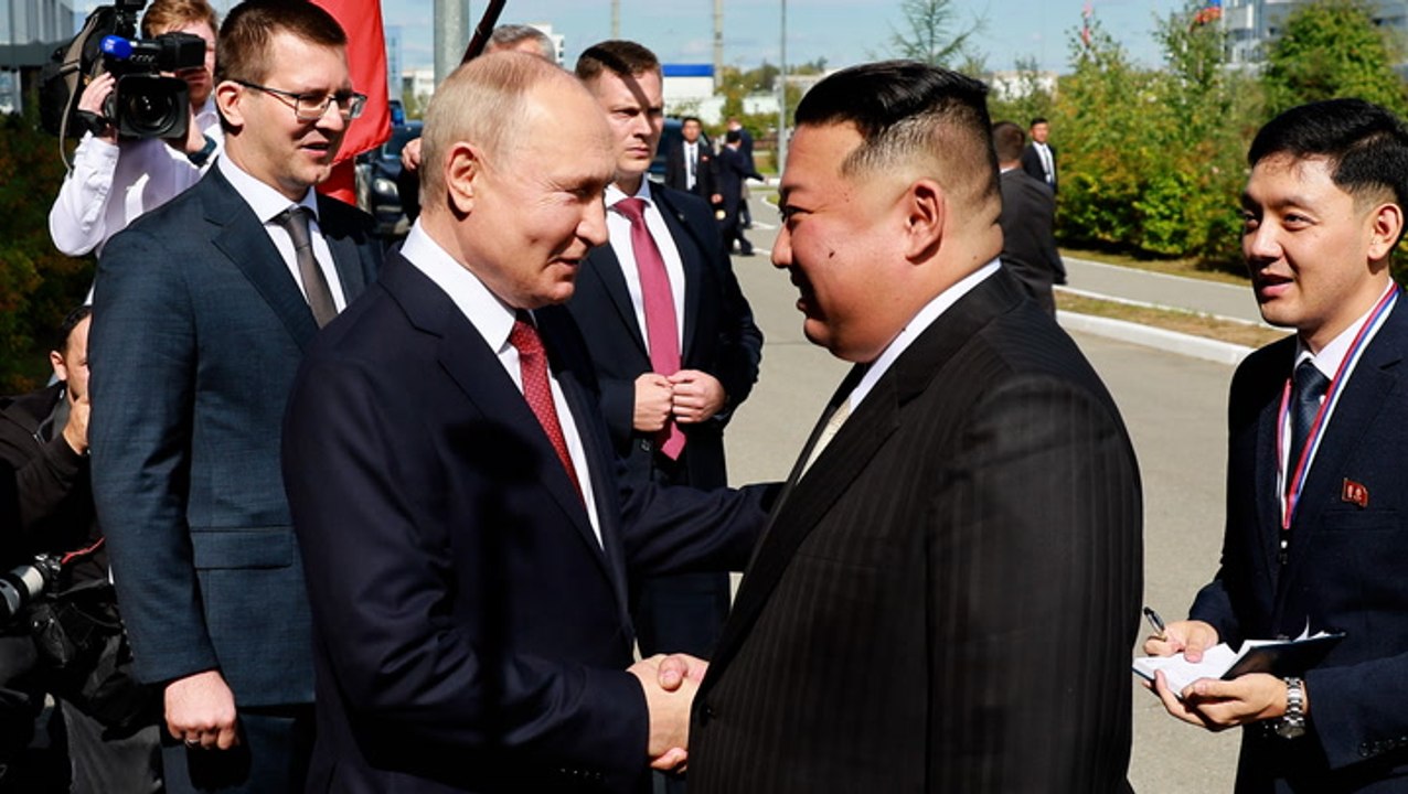 Putin and Kim Jong-un shake hands as they meet at Russian space port