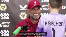 Endearing Klopp signs kid's shirt during news conference
