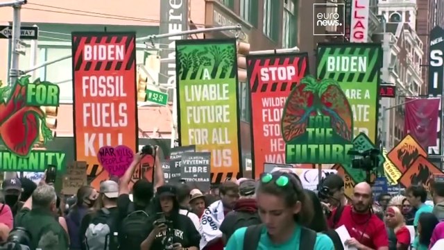 Activists spray the Brandenburg Gate orange as global protests call for end of fossil fuels