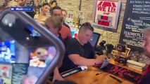 Trump dishes out slices to his supporters at Treehouse Pub in Iowa for campaign stop - and signs a VERY enthusiastic fan's top - as he brushes off claims he told aides to hide secret Mar-a-Lago docs