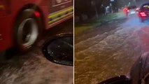 Cars splash through submerged roads as heavy flooding hits London