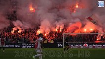 Ajax fans throw flares on the pitch to get match with rivals Feyenoord abandoned and vandalise their OWN stadium after they fell 3-0 behind - before riot police use tear gas as trouble continues outside