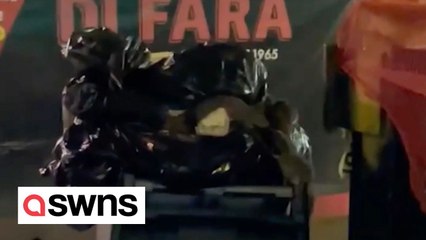 Dozens of RATS emerge from bin on New York City pavement