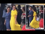Kate holds onto her yellow dress in windy arrival in Jamaica as protests erupt