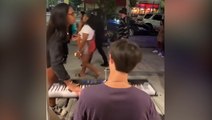 Woman knocks down street performer’s piano then allegedly steals his tips