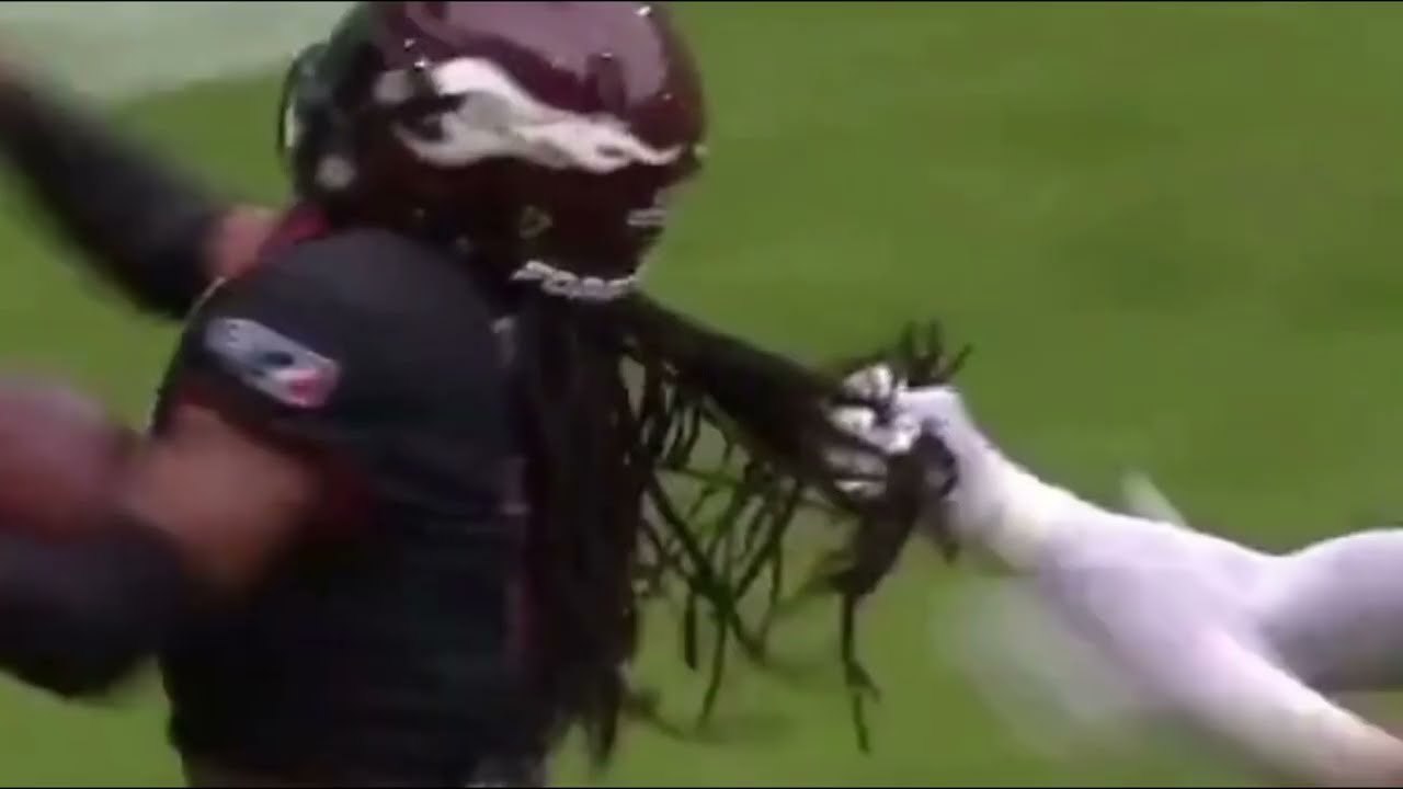 Football player tackled by his long hair during game, sparks fan