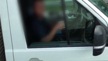 Truck driver takes both hands off steering wheel to drink cup of tea on M6