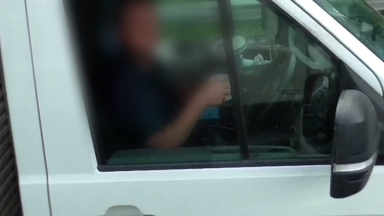 Truck driver takes both hands off steering wheel to drink cup of tea on M6