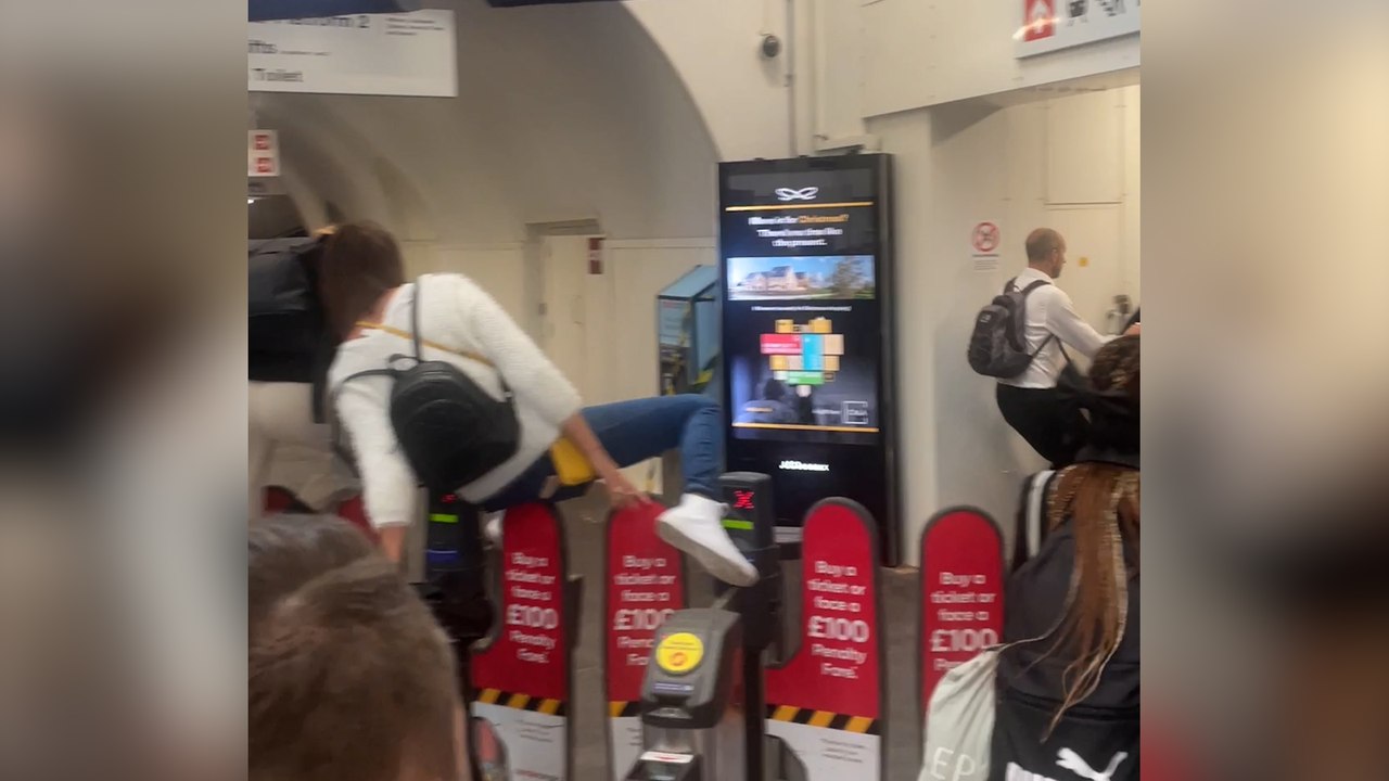 Moment commuters jumped barriers to try and catch train as strikes hit Britain