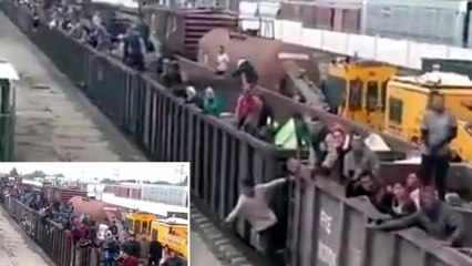 Footage shows migrants cheering as they crowd a train from Mexico headed to the US