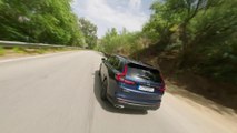 2023 Honda CR-V e:HEV in Canyon River Blue Driving in the country